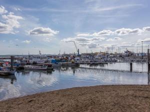 a marina with boats docked in the water at Mojo - Modern Apartment with Balcony in Poole