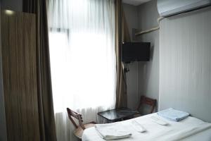 a hotel room with a bed and a window at Family Hotel Taksim in Istanbul