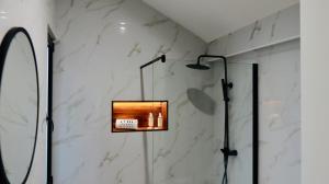 a shower in a bathroom with two lights on the wall at Oak Retreat House in Lagoa +45 photos