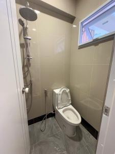 ein kleines Badezimmer mit Toilette und Dusche in der Unterkunft Apartment Near Big Buddha in Bangkok Yai