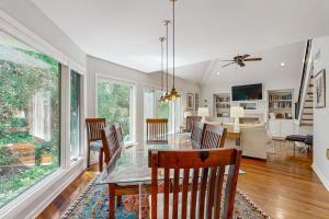 a dining room with a glass table and chairs at Spinnaker 780 in Seabrook Island