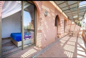 a balcony with a blue bed in a building at Palmeraie Village 2 in Marrakesh