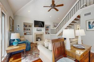 a living room with a couch and a fireplace at Spinnaker 780 in Seabrook Island