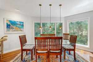 a dining room with a glass table and chairs at Spinnaker 780 in Seabrook Island +23 photos