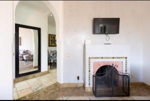 a living room with a fireplace with a tv above it at Palmeraie Village 2 in Marrakesh