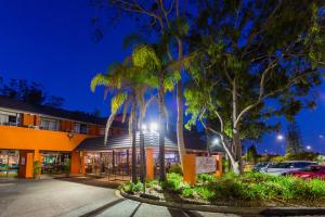 a building with palm trees in front of it at Markets Hotel in Sydney