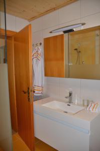 a bathroom with a sink and a mirror at Ferienwohnung Grössenberg in Weißkirchen in Steiermark