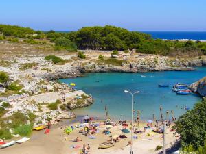 a beach with a bunch of people in the water at Tenuta Innocenzi in Sanarica