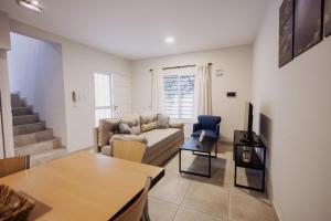 a living room with a couch and a table at Complejo Coirón in San Rafael