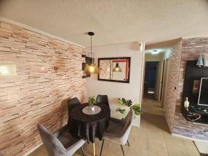 a dining room with a table and chairs at Hermoso departamento in Puerto Montt