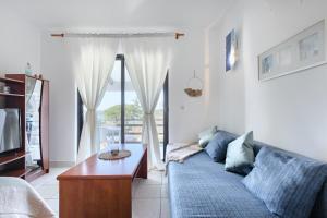 a living room with a blue couch and a table at Apartment Eli in Banjole