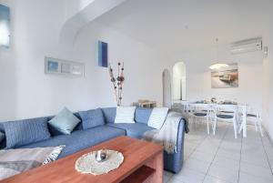 a living room with a blue couch and a table at Apartment Eli in Banjole