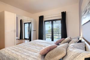 a bedroom with a large bed with pillows on it at Apartment Eli in Banjole