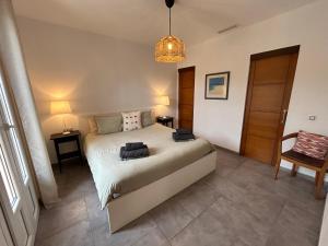 a bedroom with a bed and a pendant light at Villa A&M. Beautiful House in Puerto de Andratx in Port d’Andratx