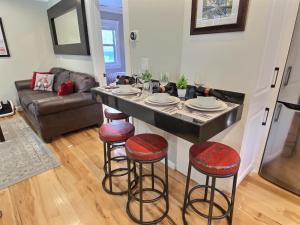 a kitchen and living room with a bar with stools at 1150 Empire Skiers Little Secret! by SkyRun Park City in Park City