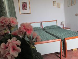 Una cama o camas en una habitación de Affittacamere Villa Delia