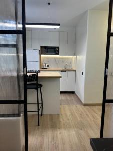 a kitchen with a chair in an empty room at Victoria apartments center in Tiraspol +13 photos