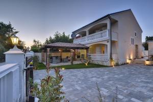 a house with a patio and a white fence at Villa Sonja in Medulin
