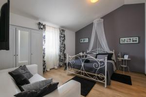 a bedroom with a bed and a couch at Villa Laura in Krnica +57 photos