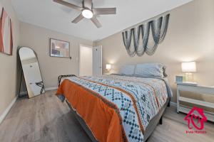 a bedroom with a bed and a ceiling fan at Chapala Charm 6BR Family Oasis - An Irvie Home in Albuquerque
