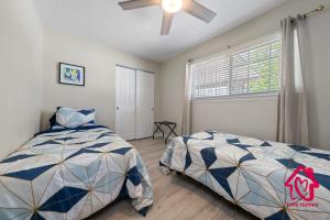 a bedroom with two beds and a window at Chapala Charm 6BR Family Oasis - An Irvie Home in Albuquerque +62 photos