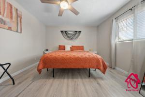 a bedroom with a bed and a ceiling fan at Chapala Charm 6BR Family Oasis - An Irvie Home in Albuquerque