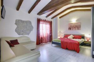 a bedroom with a bed and a couch in a room at Villa Bella in Paz +24 photos