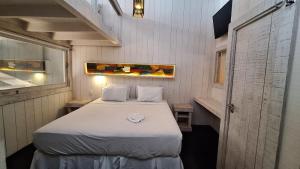 a small room with a bed and a window at As Palhas in Amontada