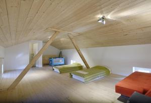 a room with two beds and a wooden ceiling at Villa Krase in Svetvinčenat