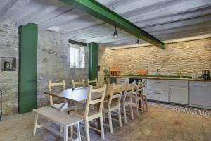 a kitchen with a wooden table and chairs at Villa Krase in Svetvinčenat