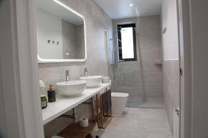 a bathroom with two sinks and a toilet at La Estrella de Tarsis in Santillana del Mar +54 photos
