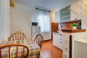 a kitchen and dining room with a table and chairs at Apartments Aurora in Pomer