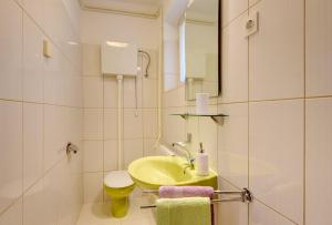 a bathroom with a sink and a toilet and a mirror at Apartments Aurora in Pomer +14 photos