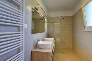 a bathroom with two sinks and a shower at House Bellissima in Vodnjan +29 photos