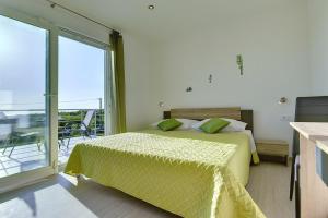 a bedroom with a bed and a large window at House Bellissima in Vodnjan