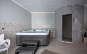 a bathroom with a tub and a sink at Ferienwohnung 5235-2 in Drenje in Drenje +29 photos