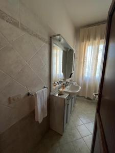 a bathroom with a sink and a mirror at Villetta dei nonni in Monsummano Terme +26 photos