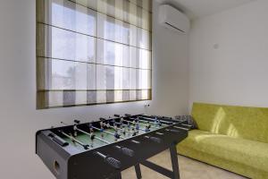 a gas stove in a living room with a couch at Apartment Falu in Štinjan