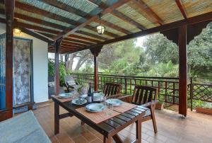 a wooden table and chairs on a porch with a table and chairs at Villa Mima in Banjole