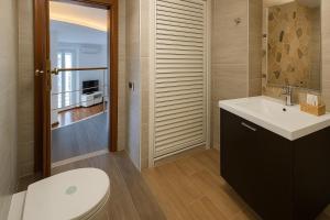 a bathroom with a white toilet and a sink at LA CASA SULL’ ACQUA in Naples +50 photos
