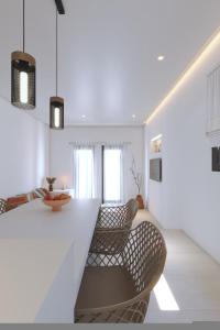 a living room with two chairs and a counter at 3-bedroom villa Penelope in Andiparos