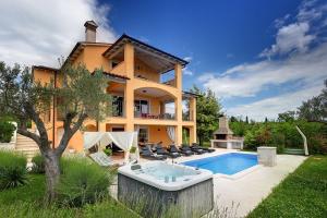 a villa with a swimming pool and a house at Villa Ari in Krnica