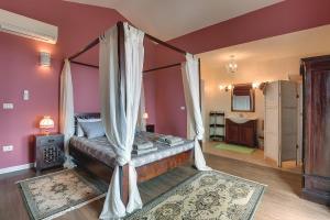 a bedroom with a bed with a canopy at Villa Ari in Krnica +24 photos