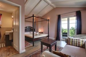 a bedroom with a canopy bed and a living room at Villa Oliva in Krnica +22 photos