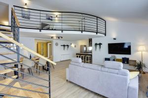 a living room with a couch and a staircase at Apartments Sunset in Vodnjan