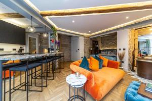 an open kitchen and living room with an orange couch at Canon Cave in Edinburgh +30 photos
