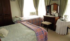 A bed or beds in a room at Beechwood House