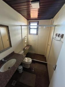 a bathroom with a toilet and a sink and a mirror at Morada das marés in Angra dos Reis +72 photos