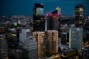 a city skyline at night with many tall buildings at J&K Platinum Towers in Warsaw