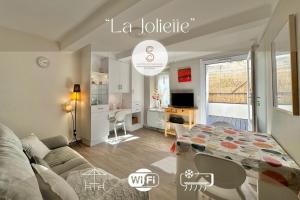 a living room with a couch and a table at La Joliette Arles centre in Arles